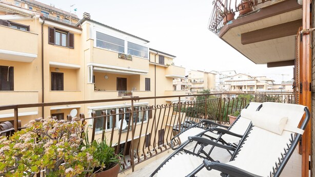 A balcony with sun loungers and potted plants. - Apartment in Via Genova in Ladispoli a few steps from the sea and train station (Ladispoli)
