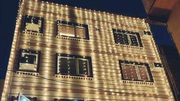 A multi-story building with a sign reading "HOTEL SHIVALAYAM" at the entrance. - Hotel Shivalayam (Varanasi)
