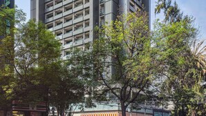 A modern high-rise building with multiple balconies and a glass facade. - Kukun Homero Polanco (Mexico City)