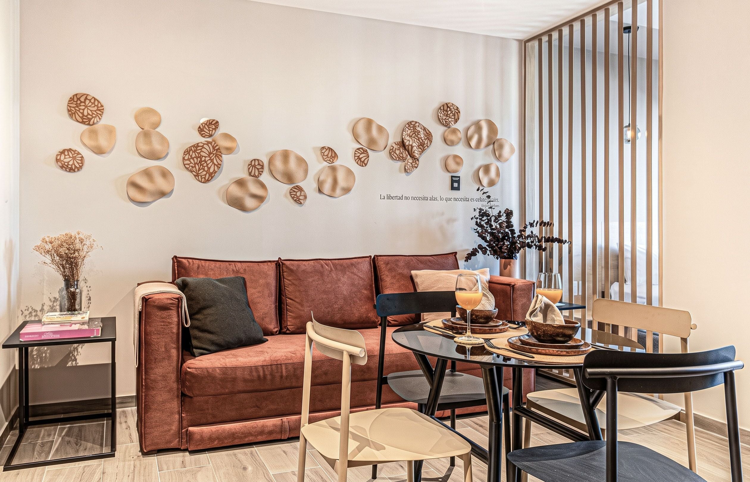 A modern living room with a sofa, chairs, a coffee table, and decorative wall art.