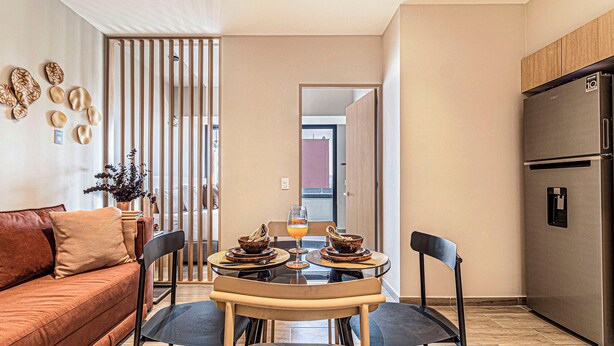 A modern kitchen with a dining table, chairs, and a refrigerator. - Kukun Homero Polanco (Mexico City)
