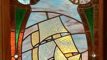 A stained glass window with a ship design.