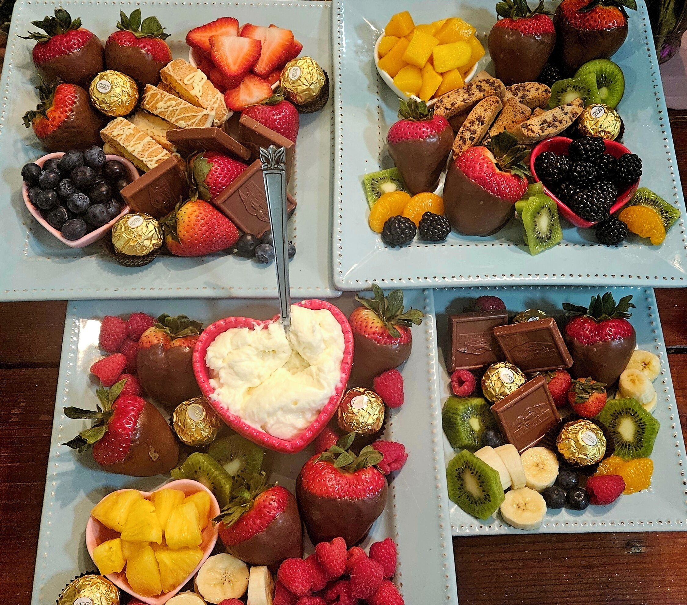 Three plates of assorted chocolates and fruits.