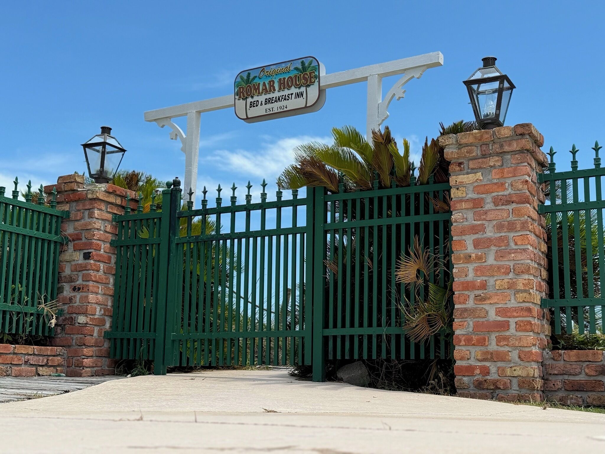 A gated entrance with a sign for the original Romar House Bed & Breakfast Inn, established in 1924.