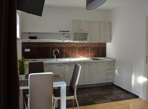 Fridge, stovetop, toaster, cookware/dishes/utensils