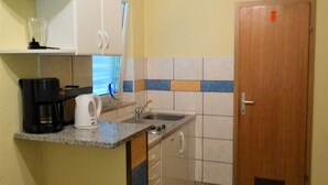 A small kitchenette with a coffee maker, kettle, and sink. - Crikvenica Apartments and Rooms with Sea View - One Bedroom Apartment with Sea View (Crikvenica)
