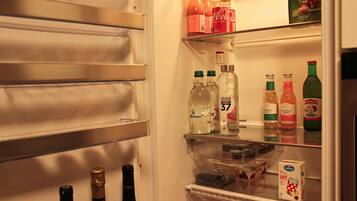 A refrigerator stocked with beverages and food items.