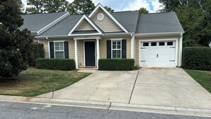 A single-story house with a front garage, a covered porch, and a well-maintained lawn. - Charming 2-bedroom building in fabulous Augusta with AC, WiFi (Augusta)