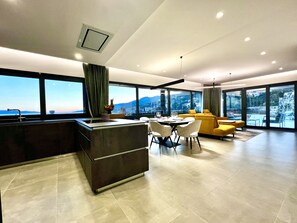 Enjoy expansive views of the surrounding landscape from the large windows in this contemporary living space.