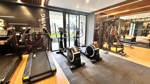 A gym with treadmills, elliptical machines, and weight machines. - Apartment in Barranco by Artline (Lima)