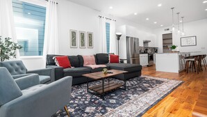 A modern living room with a sofa, armchairs, a coffee table, and a patterned rug. - Spacious ATL Escape, Prime Area Near Everything! 2 King Beds. Walkable & Central (Atlanta)