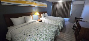 A hotel room with two beds, a desk, and a chair. - HomeTowne Studios by Red Roof LaGrange (LaGrange)