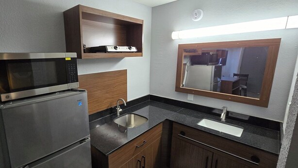 Full-sized fridge, microwave, cookware/dishes/utensils, dining tables - HomeTowne Studios by Red Roof LaGrange (LaGrange)