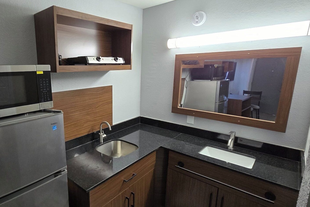 Full-sized fridge, microwave, cookware/dishes/utensils, dining tables