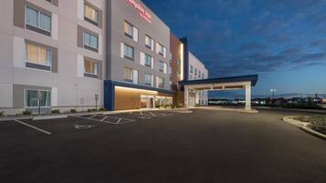 A Hampton Inn by Hilton hotel with a spacious parking lot and a covered entrance.