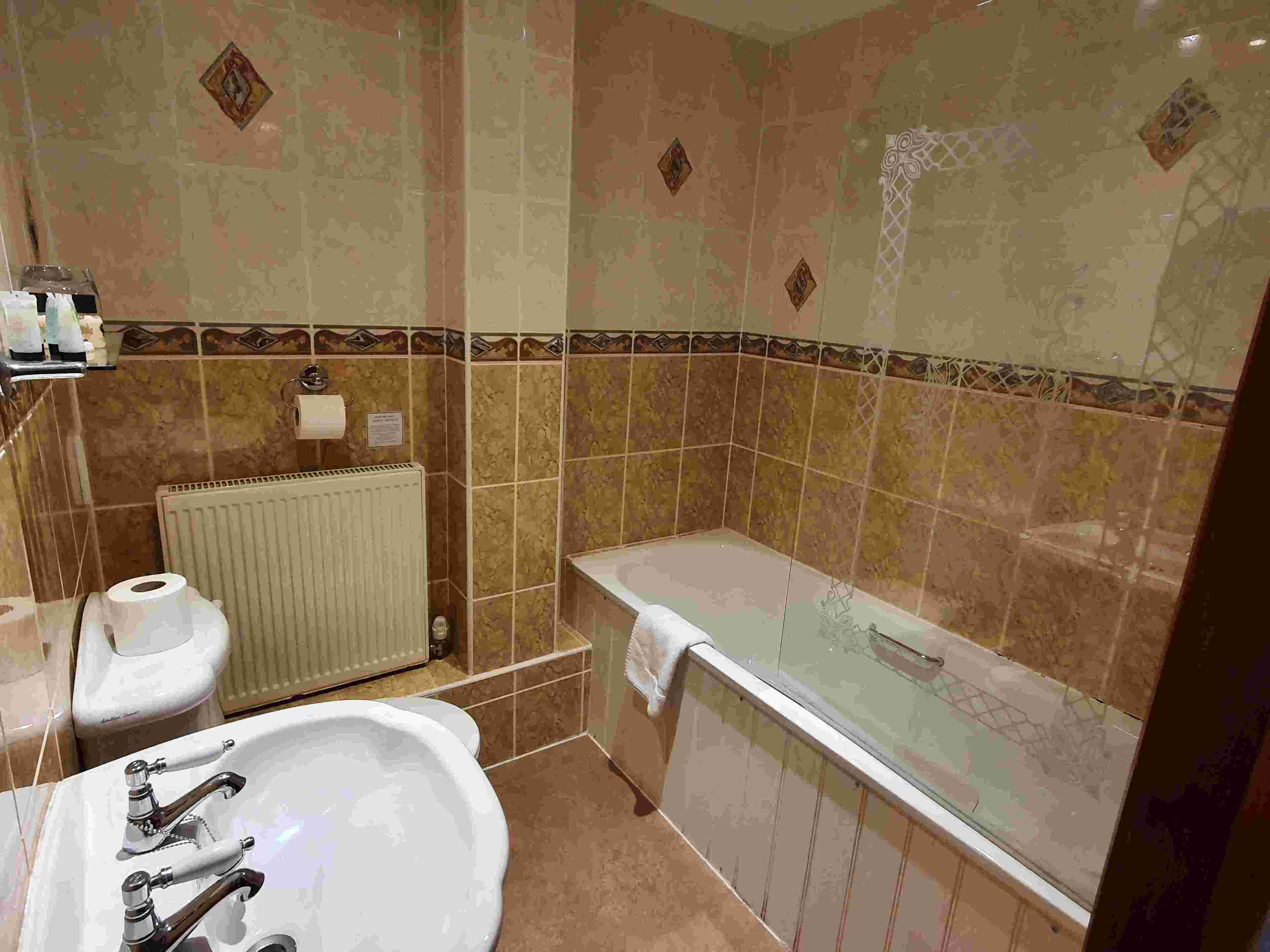 A bathroom with a bathtub, a sink, and a toilet.