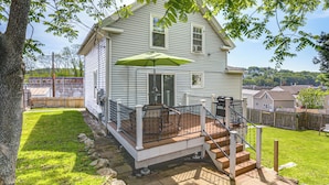 A two-story house with a covered patio, a staircase, and a green umbrella. - Home Near Parks & Downtown Worcester (Worcester)