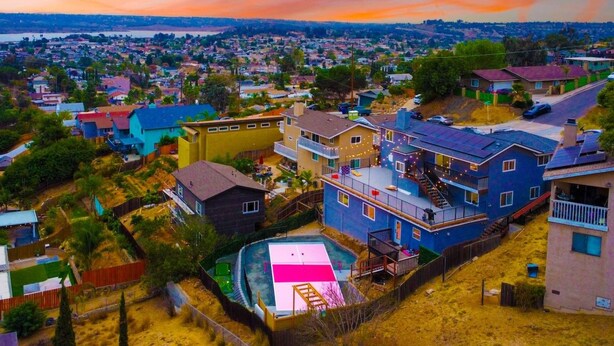 A residential area with houses, a swimming pool, and a view of a distant town. - SD Lux Oasis: Theatre, Spa, 14Beds, AC, Sleeps 20+ (Spring Valley)