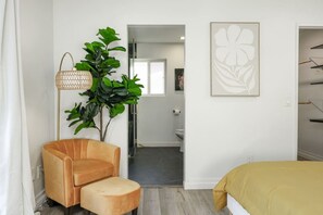 A modern bedroom with a sofa, a floor lamp, and a painting. - SD Lux Oasis: Theatre, Spa, 14Beds, AC, Sleeps 20+ (Spring Valley)