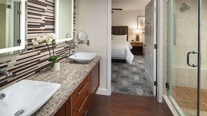 A modern bathroom with a double sink, a large mirror, and a shower area. - BNP Paribas Open Tennis Indian Wells 
Marriott Shadow ridge enclaves 2 bed villa (Palm Desert)