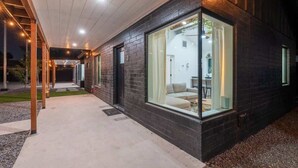 A modern building with large glass windows, a concrete pathway, and a brick exterior. - Shared fun Pickleball, Theater & Pool | DT Phoenix (Phoenix)