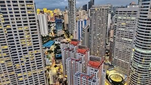 A high-rise urban area with modern architecture, including a mix of high-rise buildings and a prominent curved building.
