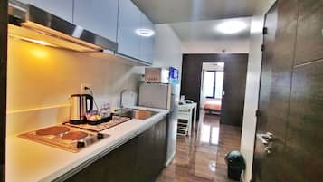 Full-size fridge, stovetop, rice cooker, cookware/dishes/utensils
