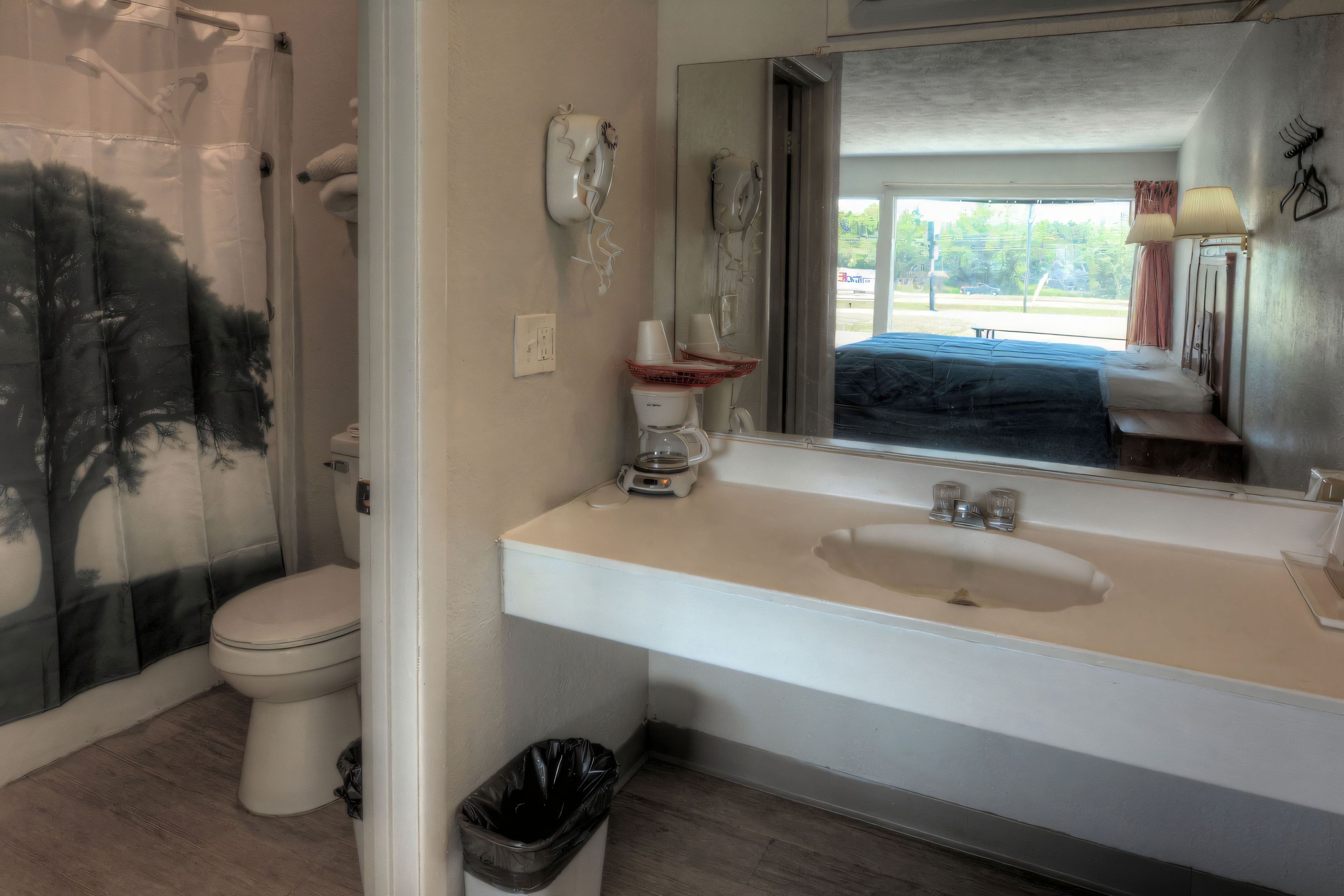 A bathroom with a toilet, sink, and shower.