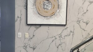 A marble staircase with a framed artwork on the wall. - Charming 4-bedroom house with AC and WiFi in fabulous Punta Cana (Punta Cana)