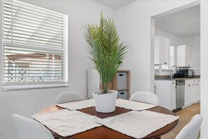 A modern kitchen with white cabinets, a built-in oven, and a coffee machine. - Nestled in North Port.  Updated 2 Bed / 1 Bath. (North Port)