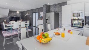 A modern kitchen with white cabinets, a built-in oven, and a microwave. - Vacation home Villa by Interhome (Saint Cyr sur mer Les Lecques)