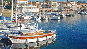 A marina with various boats docked, surrounded by buildings with red roofs and white walls. - Vacation home Villa by Interhome (Saint Cyr sur mer Les Lecques)