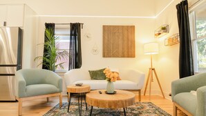 A modern living room with a sofa, two armchairs, a coffee table, a lamp, and a decorative rug. - 3-bedroom home in beautiful Atlanta. 10 mins from Mercedes Benz. FIFA World Cup (Atlanta)