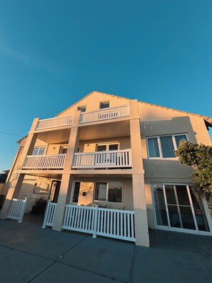 A multi-story residential building with balconies, a garage, and a gated driveway. - Beachfront apartment with pool, 4 minutes walk to Indian Ocean. Sleeps 6 (Quinns Rocks)