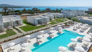 A modern resort with a large pool, outdoor seating, and a view of the sea. - Capo Falcone Charming Apartment by Interhome (Stintino)