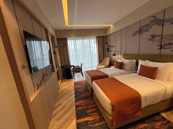 A hotel room with two beds, a television, a desk, and a chair. - Ramada Encore by Wyndham Gurugram Dwarka Expressway (Gurugram)