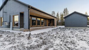 A modern two-story house with large windows and a covered porch. - Villa plywood by Interhome (Pudasjärvi)