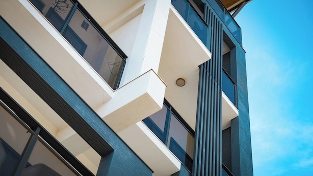 A modern building with a geometric facade, large windows, and a clear sky. - Moker House  (Jincheng)