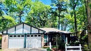 A single-story house with a garage, surrounded by trees. - House 3-Bedroom 2-Full Baths FREE Garage Parking, Washer, Dryer in The Woodlands (Spring)