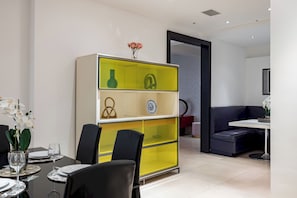 Enjoy meals in this stylish dining area with a central cabinet, dining table, and comfortable seating.