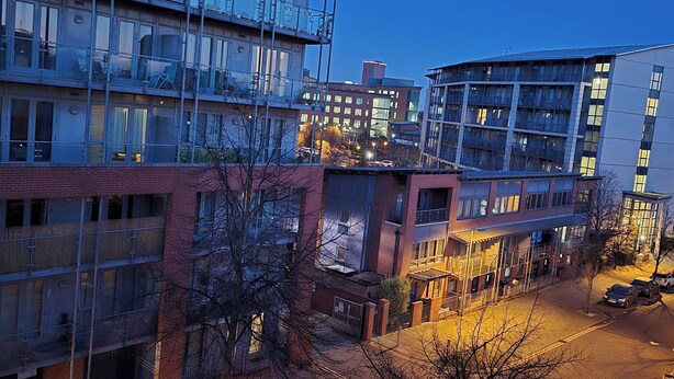 A multi-story building with a modern architectural design, featuring large windows and a mix of glass and brick facades. - City Central Apartment  (Birmingham)