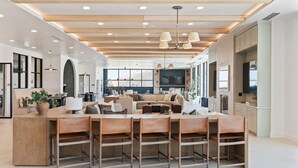 A spacious living area with a central island, seating arrangements, and a kitchen area. - INCREDIBLE Views Capital +MTN+City! Penthouse cnr suite! Best Amenities! (Salt Lake City)