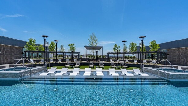 A modern outdoor pool area with lounge chairs and a pergola structure. - INCREDIBLE Views Capital +MTN+City! Penthouse cnr suite! Best Amenities! (Salt Lake City)