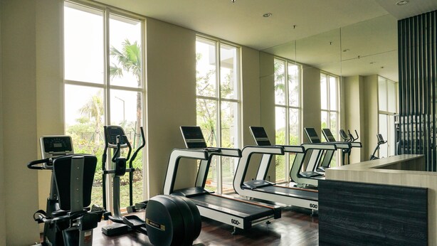 A gym with treadmills, elliptical machines, and a stationary bike. - Elegant And Spacious 1Br At Citralake Suites Apartment (Jakarta)