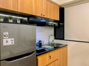 Apartment | Private kitchen | Full-sized fridge, microwave, stovetop, rice cooker - Simply And Homey 1Br With Extra Room At Meikarta Apartment (Cikarang)
