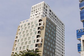 Stylish high-rise building with a unique architectural design and grid-like pattern of windows.