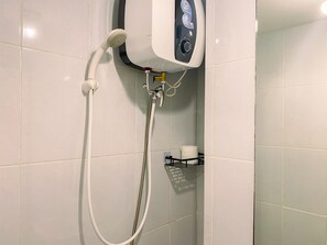 Studio | Bathroom | Shower, towels, soap, shampoo - Relaxing and Comfortable Studio at Tokyo Riverside PIK 2 Apartment  (Teluknaga)