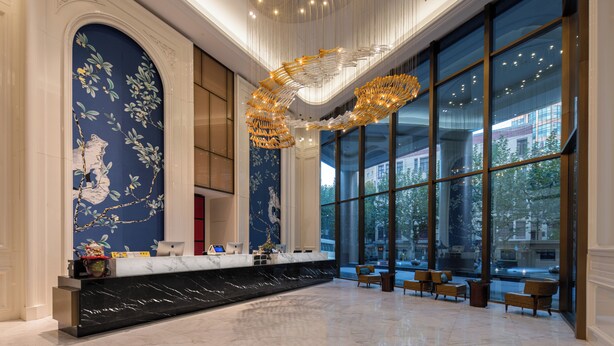 A spacious lobby with a marble reception desk, large windows offering city views, and elegant wall art. - MEHOOD LESTIE Hotel (Shanghai Xujiahui Wukang Road) (Shanghai)