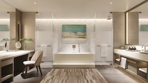 A modern bathroom with a large bathtub, a glass shower enclosure, and a large mirror. There is a chair and a small table with toiletries. - Grand Hyatt Grand Cayman Resort & SPA (Seven Mile Beach)