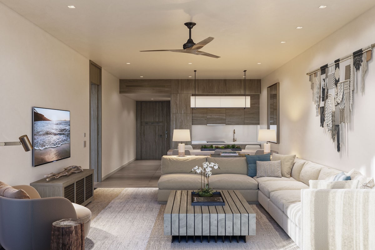 A modern living room with a sofa, coffee table, and a TV mounted on the wall.